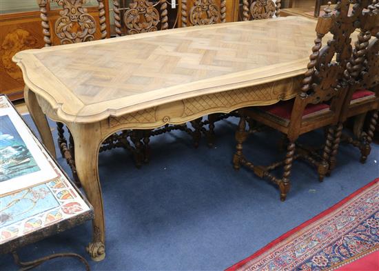 A 19th century French parquetry top dining table, on cabriole legs W.216cm